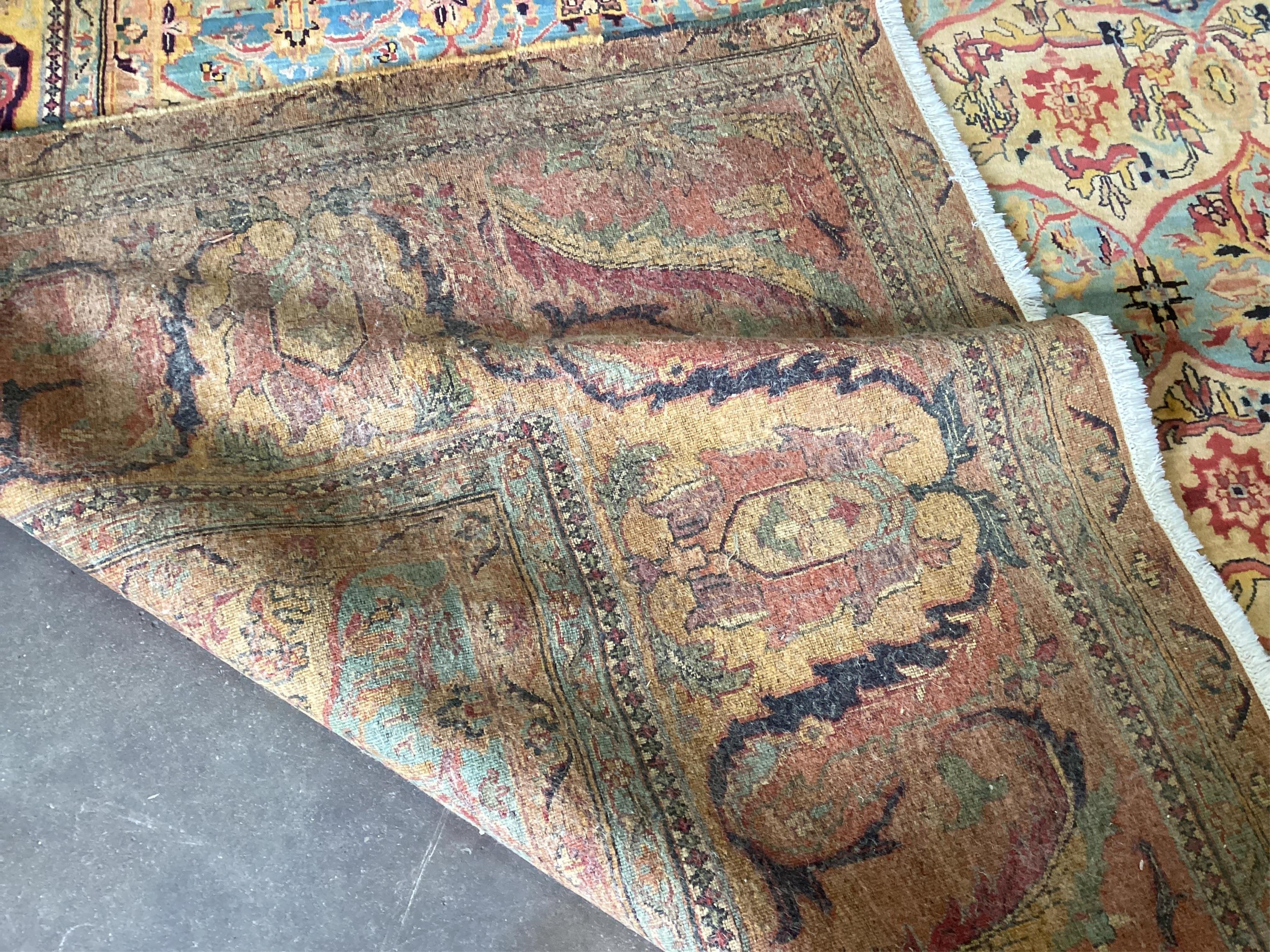 A large Persian design ivory ground carpet, 590 x 365cm. Condition - good
